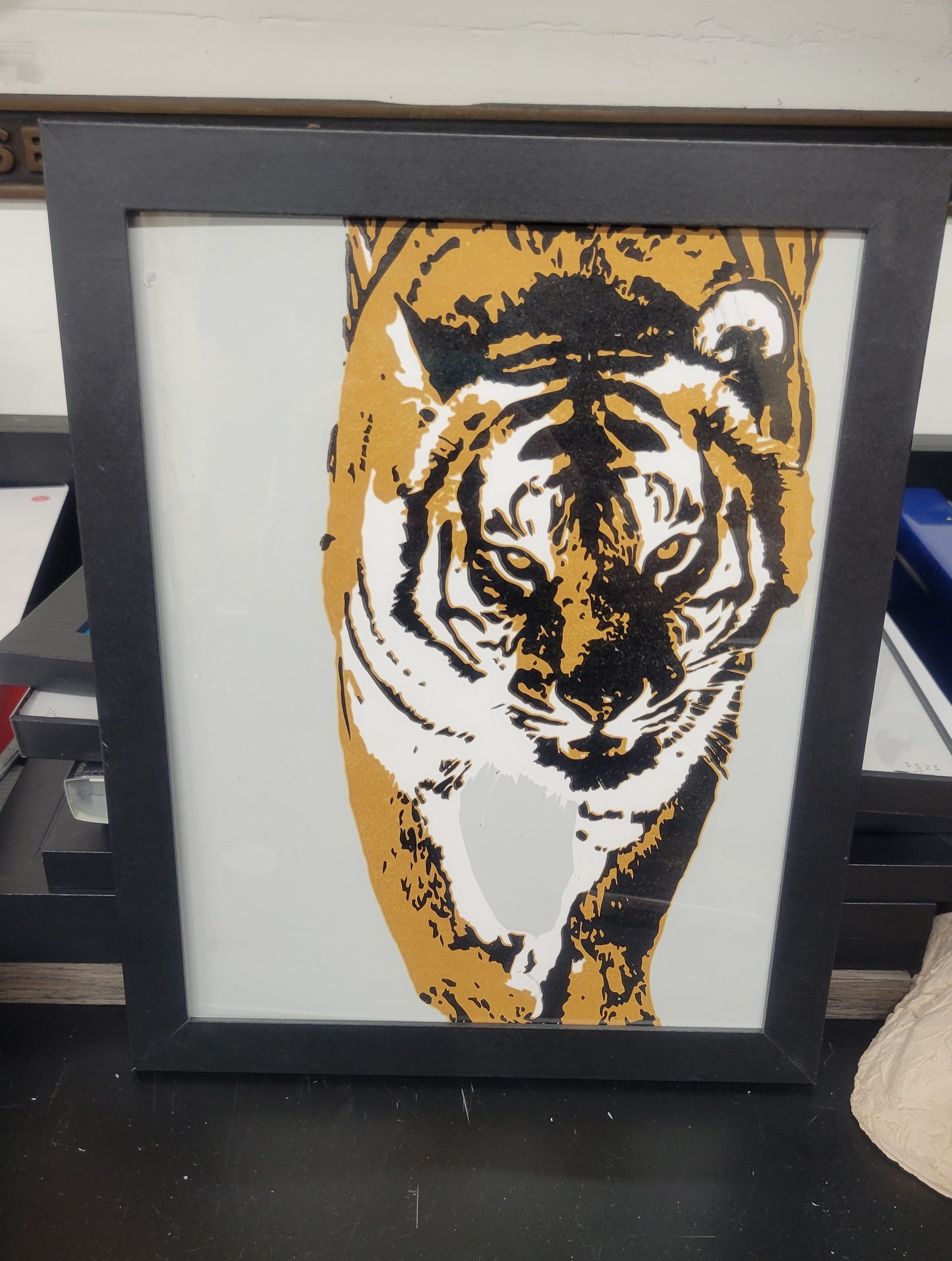 "Tiger I" a 3-color screen print by Claire Davis featuring a stylized tiger in bold, vibrant colors. 8x10 print, shown here in a simple black frame.
Original photo, digital design, and printmaking by Claire Davis