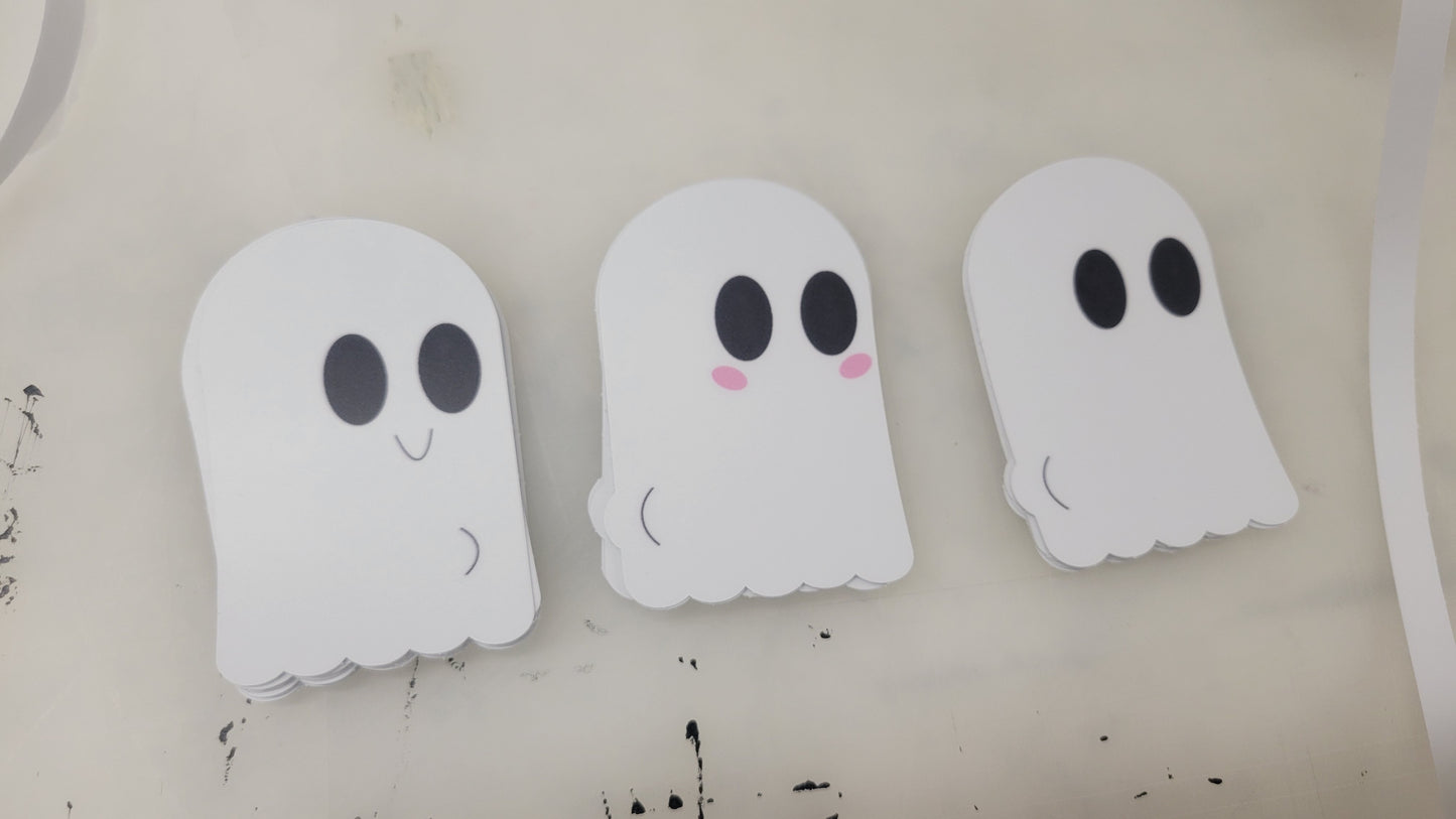 Three adorable ghost decals from InkBird Print Studio LLC's "Ghost Decals (NSFW)" lineup feature large black eyes and simple, rounded forms on a light background. The center ghost is adorned with pink blush marks on its cheeks, adding a playful touch of spookiness to any space!