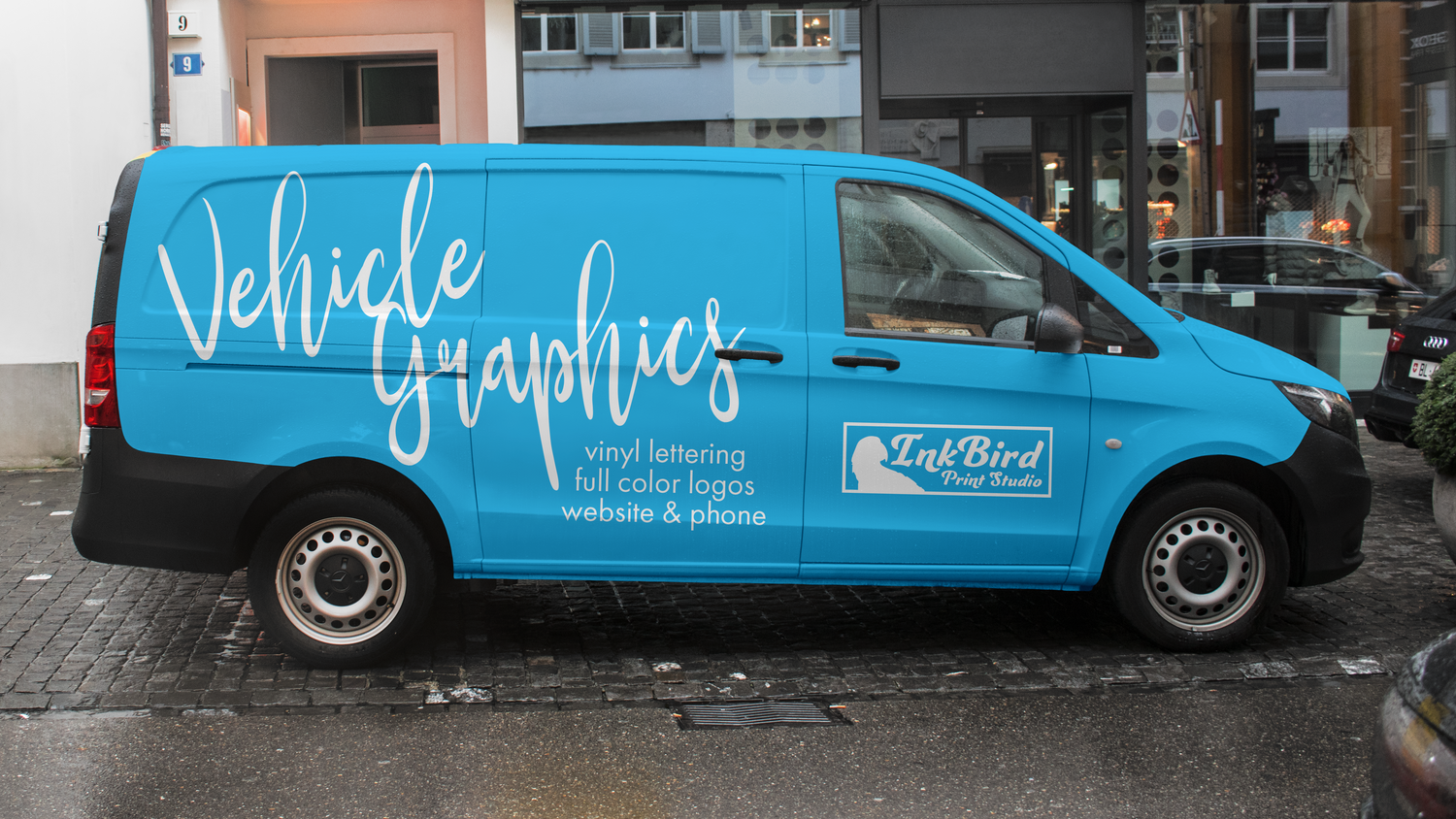 A blue mini van parked street side, with vinyl lettering and a logo applied to the outside. Custom Vehicle Graphics for vans, trucks, and trailers by InkBird Studio. DIY or we install!