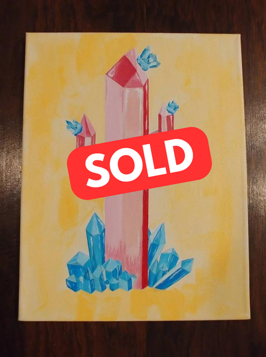 The acrylic painting "Crystal Cactus II" by Claire Davis, measuring 11"x14", features tall pink crystal cacti amid smaller blue crystal flowers set against a yellow background. A bold red SOLD sign is displayed across the center. This artwork is offered by InkBird Print Studio LLC.