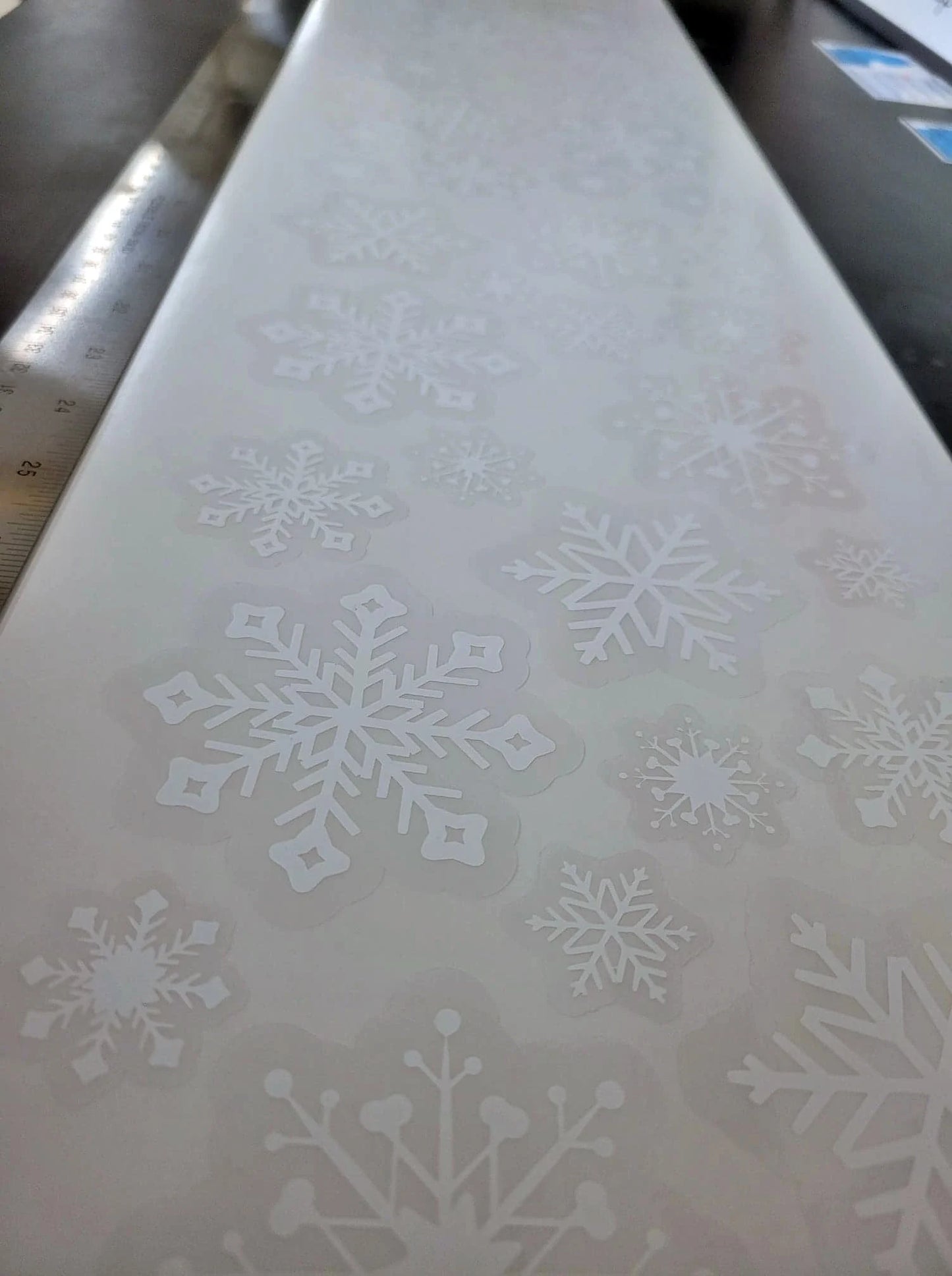 InkBird Print Studio's snowflake static cling set as it will be shipped: a variety of contour cut shapes featuring intricate snowflake designs. Renter friendly window clings, no adhesive, no residue.