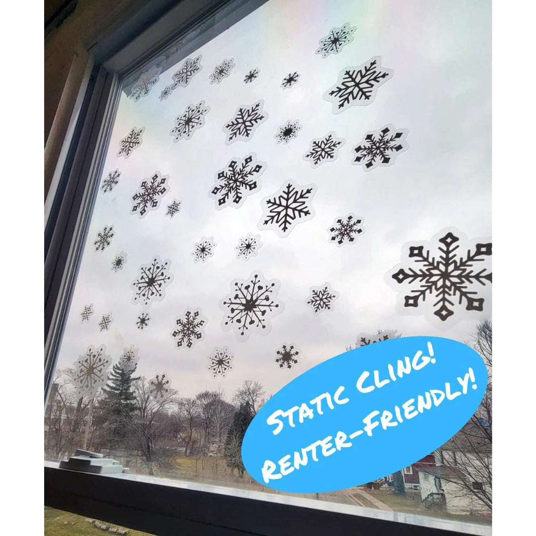 Image of static window cling snowflake decals in various intricate designs and sizes. The snowflake clings are displayed on a clear surface, showcasing their crisp, white details against a blurred background. Perfect for holiday or winter-themed decor, these reusable clings add a festive touch to windows and glass surfaces. Renter-friendly! No adhesive or residue.