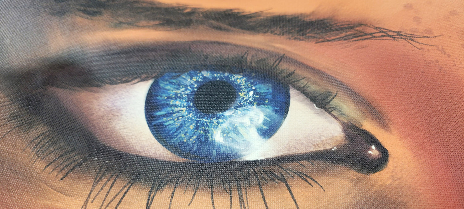 A closeup photo of an art piece printed on canvas. Bright colors and brushstrokes are clearly visible in the eye of this digital painting that has been printed on canvas at InkBird Print Studio