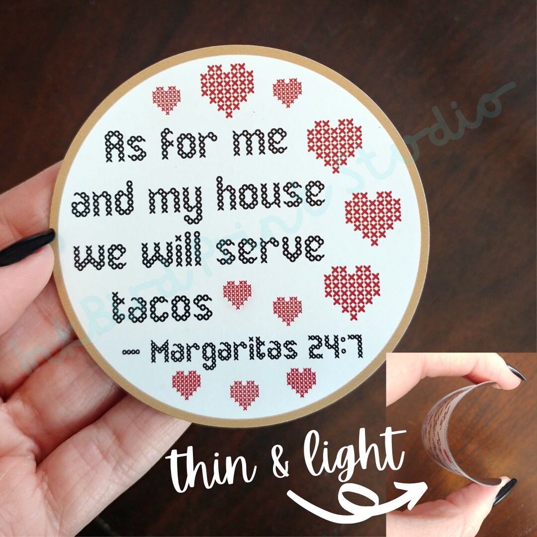 Introducing the "As for me and my house, we will serve tacos. Margaritas 24:7" Cross Stitch Design Fridge Magnet by InkBird Print Studio LLC, featuring an elegant font encircled by red hearts. Perfect as a housewarming gift, it shows its delicate thickness with "thin & light," indicated by an arrow while held up effortlessly in hand.