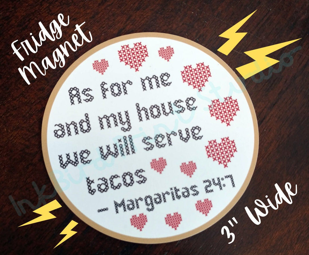 This delightful fridge magnet from InkBird Print Studio LLC, perfect for a Valentine's Day or housewarming gift, showcases a cross-stitched message: "As for me and my house, we will serve tacos. Margaritas 24:7," surrounded by charming heart designs. Measuring 3 inches wide, it stands out beautifully on a dark wooden surface.